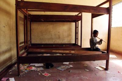 A Refugee Child Plays in a Destroyed Orphanage in Dili