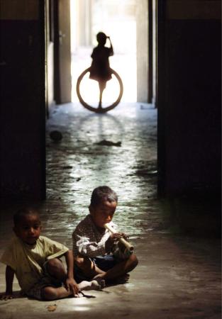 A Refugee Child Plays in a Destroyed Orphanage in Dili